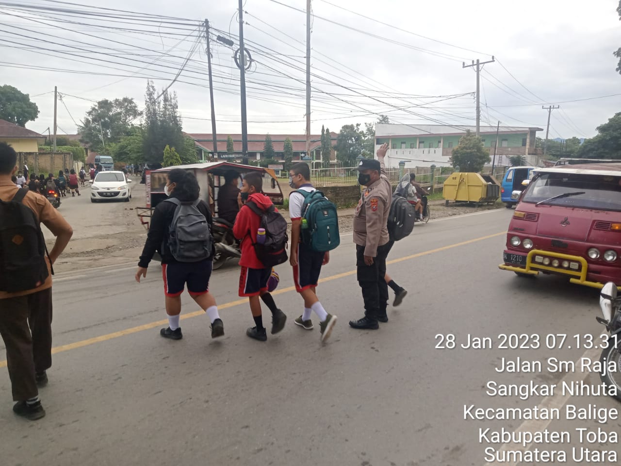 Rutinitas Gatur Lalin Pagi, Polsek Balige Bantu Menyeberangkan Anak Sekolah