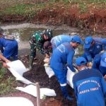 Kolaborasi Babinsa Kelurahan Lubang Buaya Bersama Petugas Dinas Tata Air Bersihkan Saluran Air